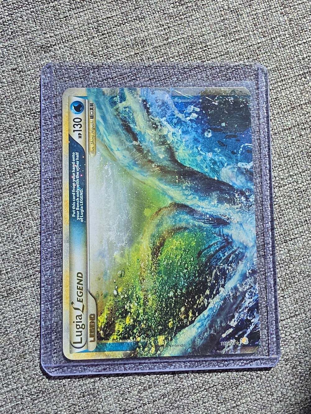 Pokemon Lugia LEGEND Card in Blue-Green Artwork with Purple Sleeve